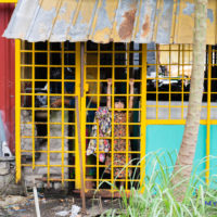 Girl at the metal grill door