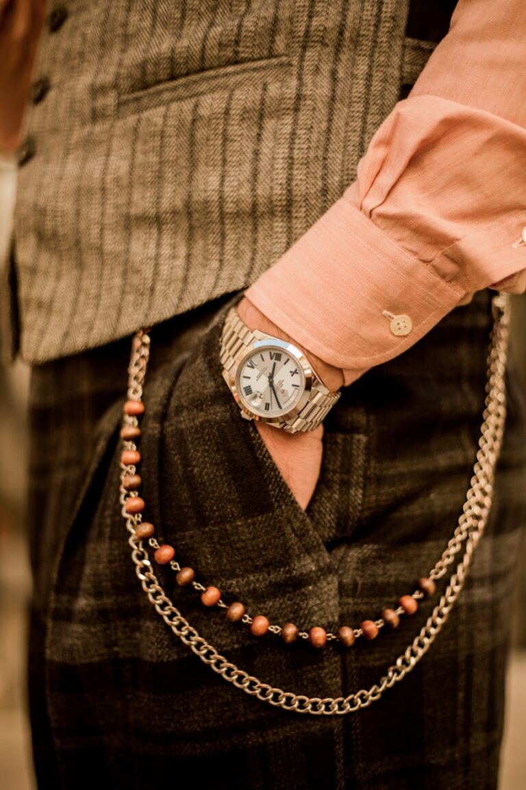 a man wearing a watch and chain