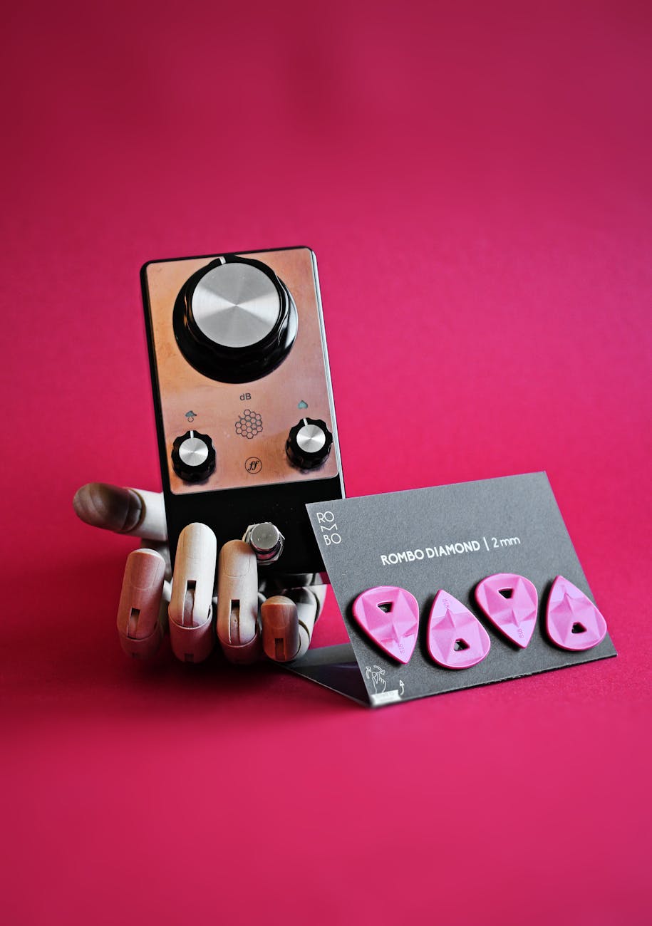 guitar picks with distortion pedal in artificial hand