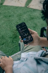 person browsing social media on smartphone outdoors