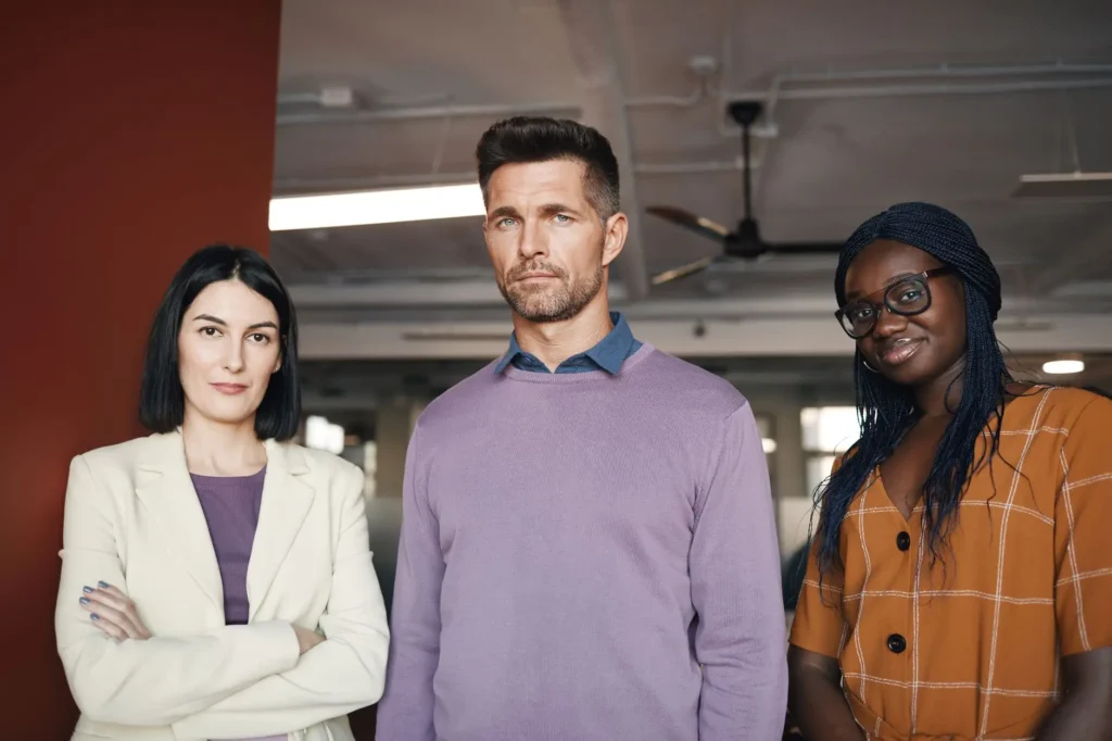 a group of people standing in the office